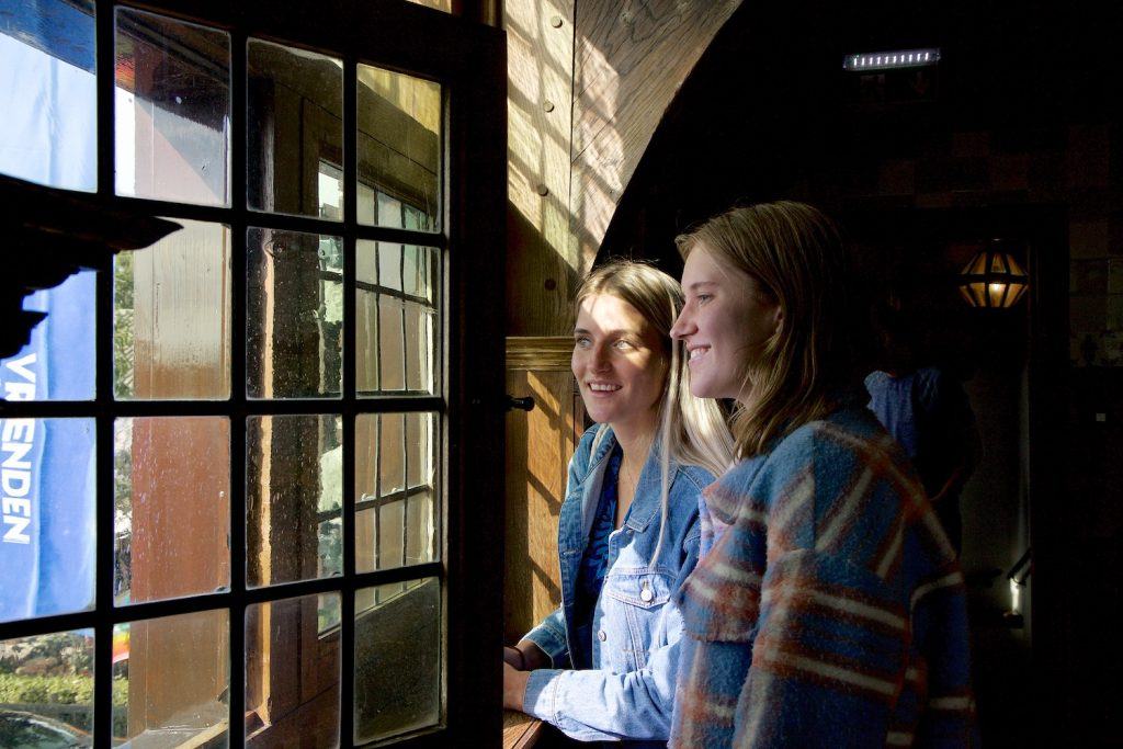 Twee jonge vrouwen kijken uit het raam van het Raadhuis in Graft. Foto Rob Verhagen.