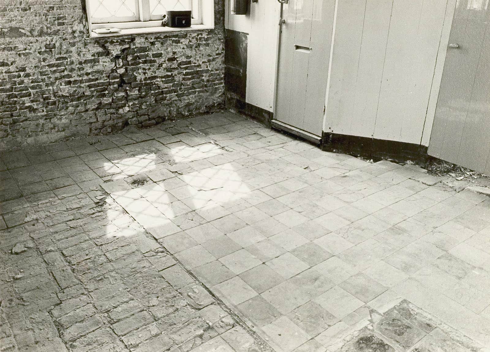 Interieur eerste verdieping. De plavuizenvloer die werd ontdekt onder een houten vloer. Foto J Elsinga 1976.