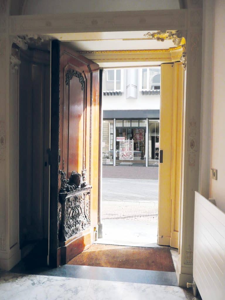 Bij het openen van de voordeur wordt
duidelijk hoe ingenieus de bouwmeester de symmetrie van de gevel heeft laten aansluiten op de asymmetrisch gelegen gang.