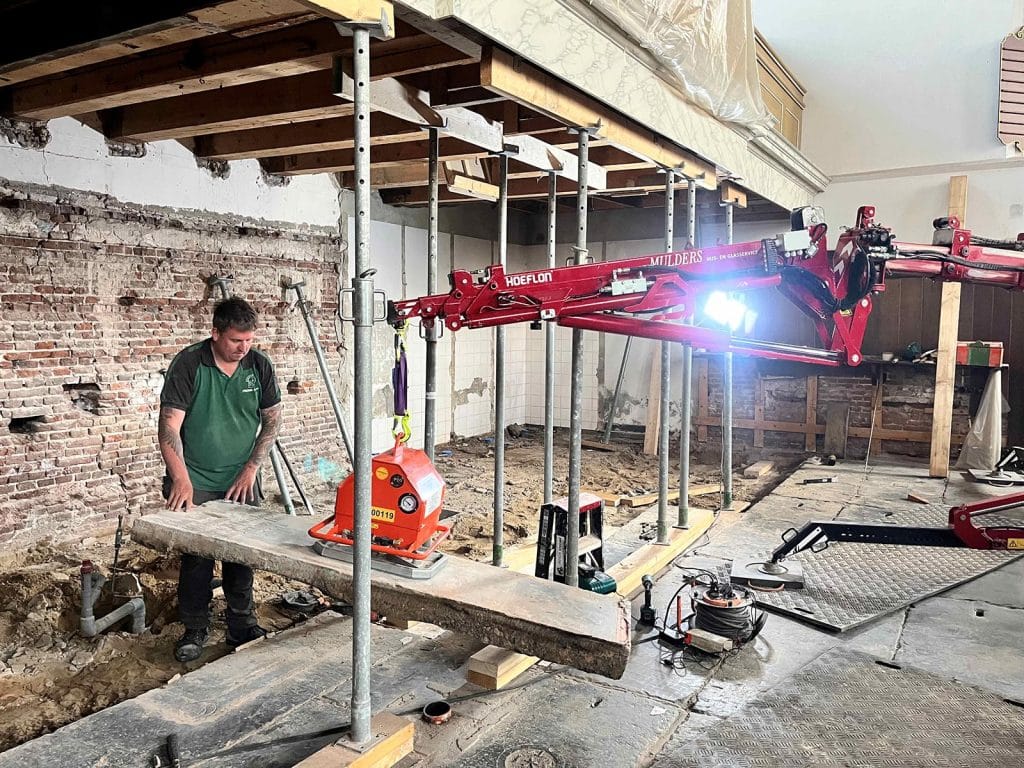 Orgelbalkon De Rijp . een zerk wordt voorzichtig gelicht met een speciale tilarm