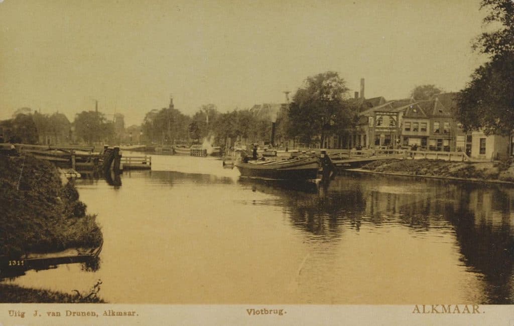 Prentbriefkaart uit circa 1907. Noordhollands Kanaal met de geopende Schermer vlotbrug. Een stoomschip passeert. Aan de overkant de Bierkade. Rechts het Luttik Oudorp ofwel de Zaadmarkt en de Rootorenbrug ofwel de Roodkorenbrug. Gezien vanaf de Eilandswal.